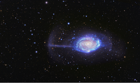 The Umbrella Galaxy takes its name from a mysterious feature seen on the left here, that is now found to be debris from a tiny galaxy, only a 50th its size. Via BlackBird Remote Observatory Telescope and Subaru Telescope.