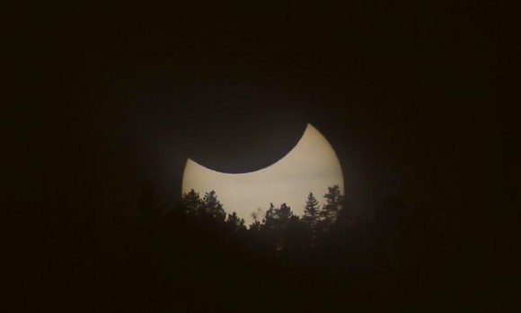 Solar eclipse over the Flatirons near Boulder, Colorado. A syzygy, with the Earth and Moon simultaneously transiting the Sun. Credit and copyright: Alex Parker.