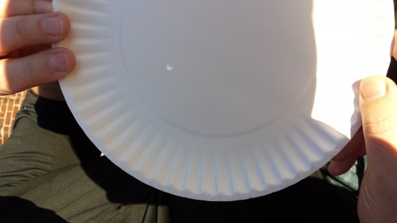 The partial solar eclipse as viewed through a paper plate pinhole projector. Credit, copyright and pinhole: Nancy Atkinson.