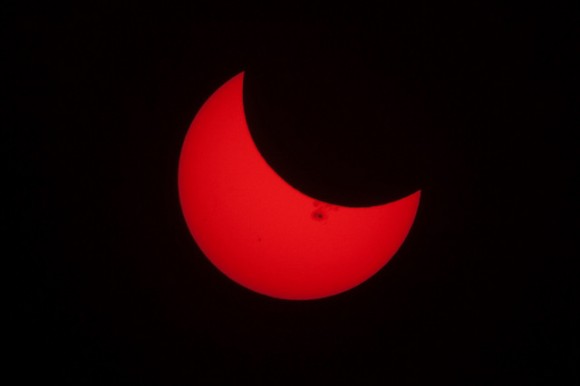 The partial solar eclipse of October 23, 2014, with a giant sunspot visible. Credit and copyright: Derek Mellott