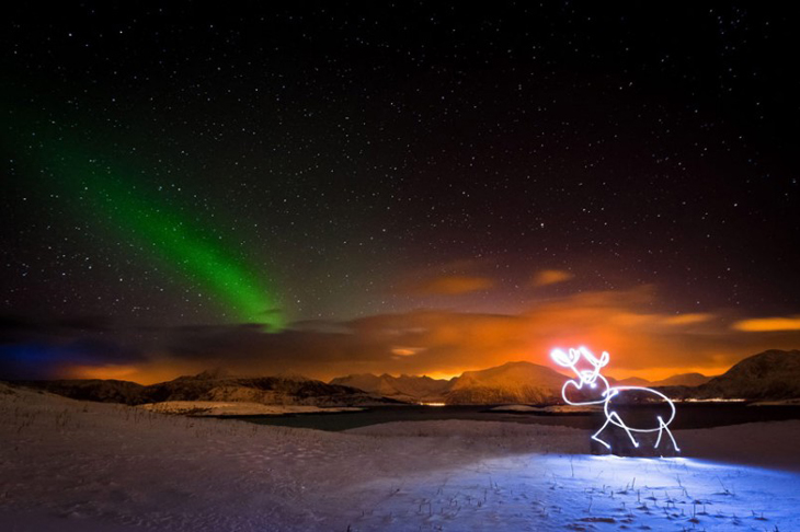 Light Painting...PIC BY REGIS  MATTHEY / CATERS NEWS - (PICTURED Light painting of a reindeer underneath the Northern Lights in Norway) A photographer has brought a series of pictures taken in the middle of the night to life - by using spectacular light paintings to outline imaginary people. In one scene an empty playground becomes filled with excitable children and in another a basketball court is lit up with a player preparing to take aim. Swiss photographer Regis Matthey, 25, creates his art using a long exposure shot meaning he only has several seconds to draw the paintings before the camera shutter closes. And despite his stunning results Regis, who captured the images at various locations near the Swiss town of La Vallee de Joux, insists you only need basic equipment to create such work. 