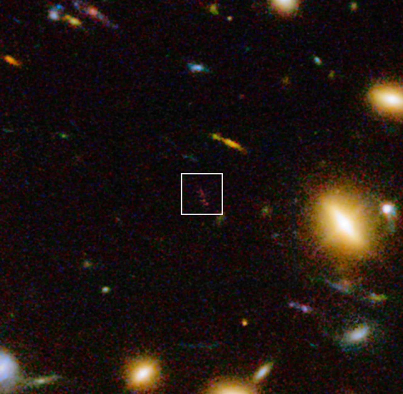 Infrared/visible-light view of the distant dusty galaxy A1689-zD1 behind the galaxy cluster Abell 1689 (Credit: ESO/J. Richard)