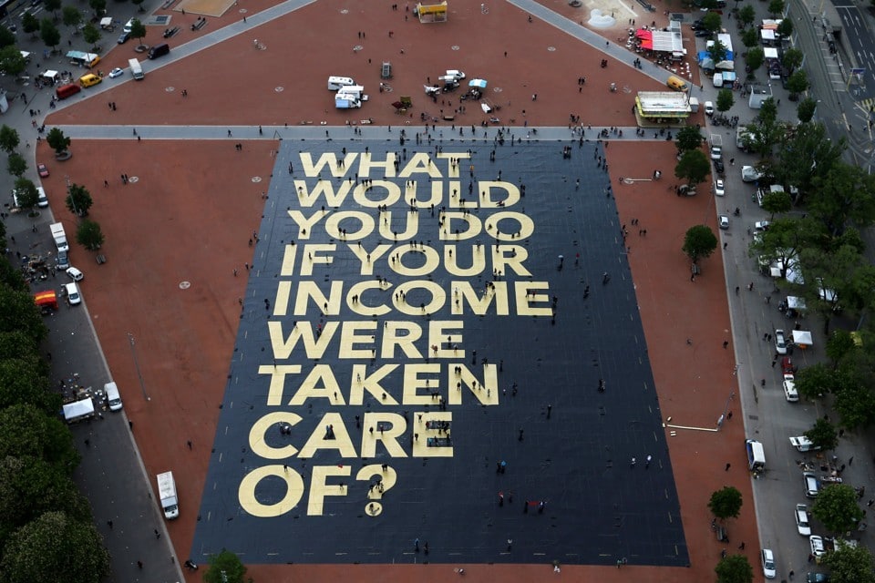 A pro-UBI poster in a square in Geneva, Switzerland. Denis Balibouse / Reuters.