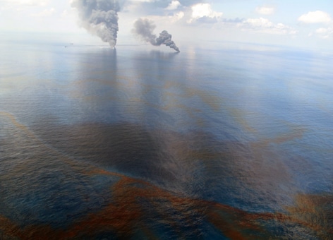 Smoke is visible from controlled burns of the oil released during the Deepwater Horizon oil spill in 2010. This oil well blowout was the largest oil spill in U.S. waters. (NOAA)