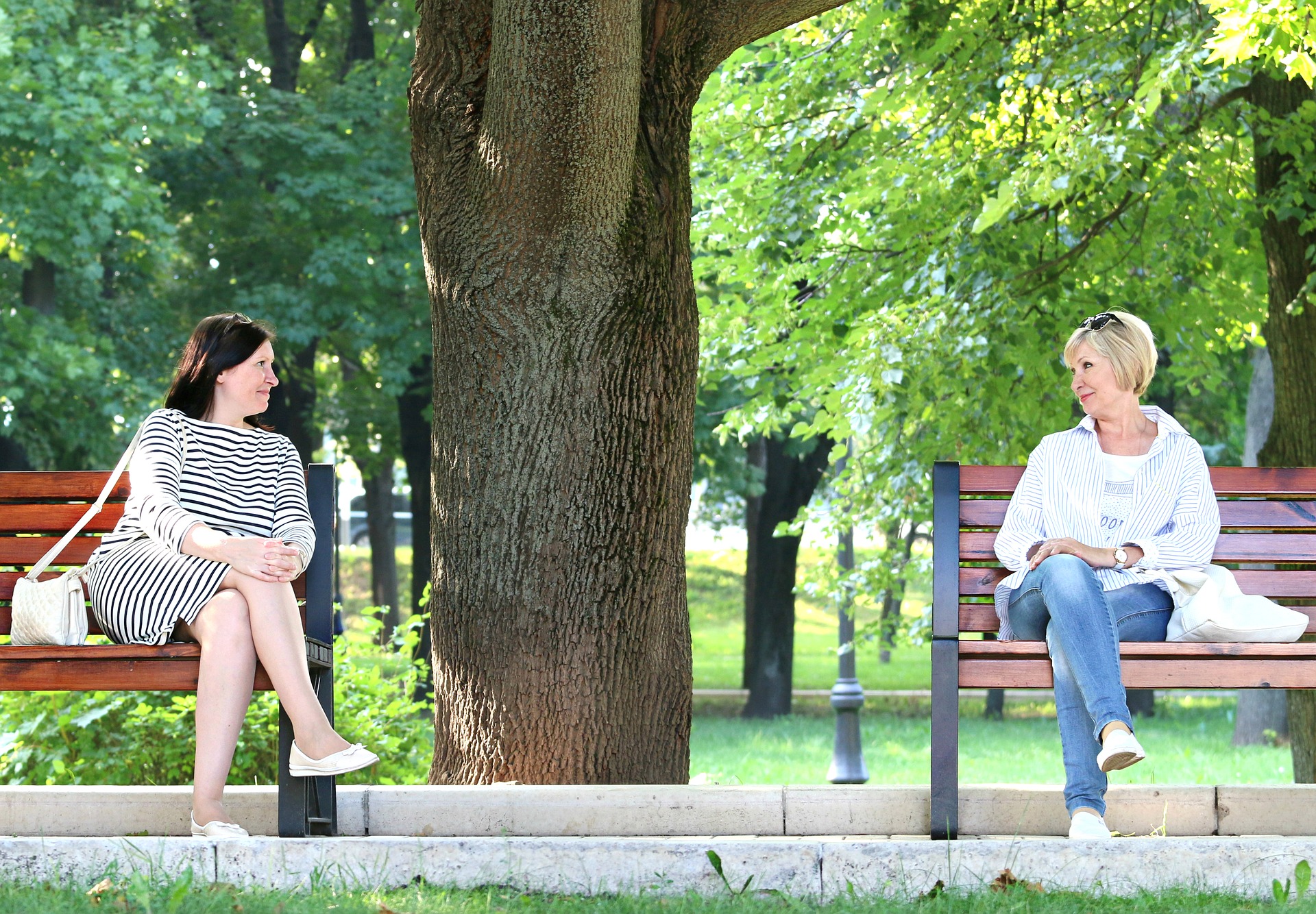 Two women stare at each other from different benches - or, how many of us feel when facts don't work.