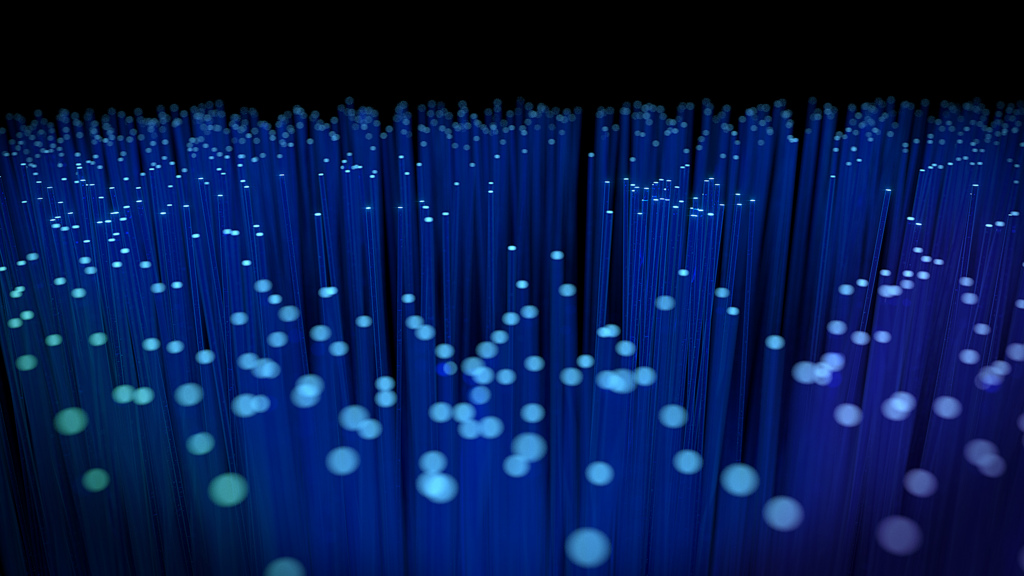 A field of blue-tipped fiber optic cables. This new innovation could up the efficiency of fiber optic transmissions, leading to faster internet speeds.