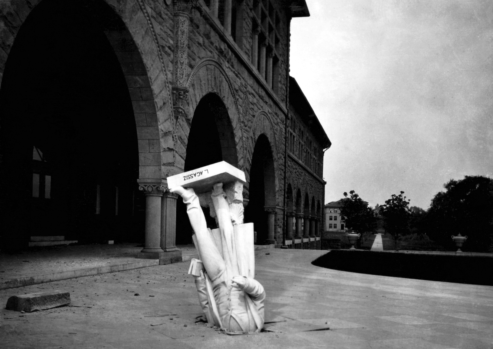 A statue of Louis Agassiz upturned on the Stanford University campus during a 1906 earthquake. 