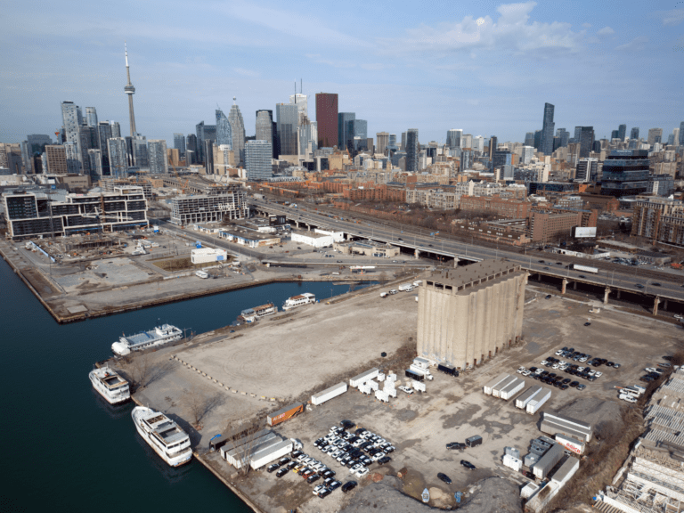 The Eastern waterfront, future site of the Toronto smart city project, today: mostly empty industrial lots with a few old concrete buildings, storage containers, and parked cars.