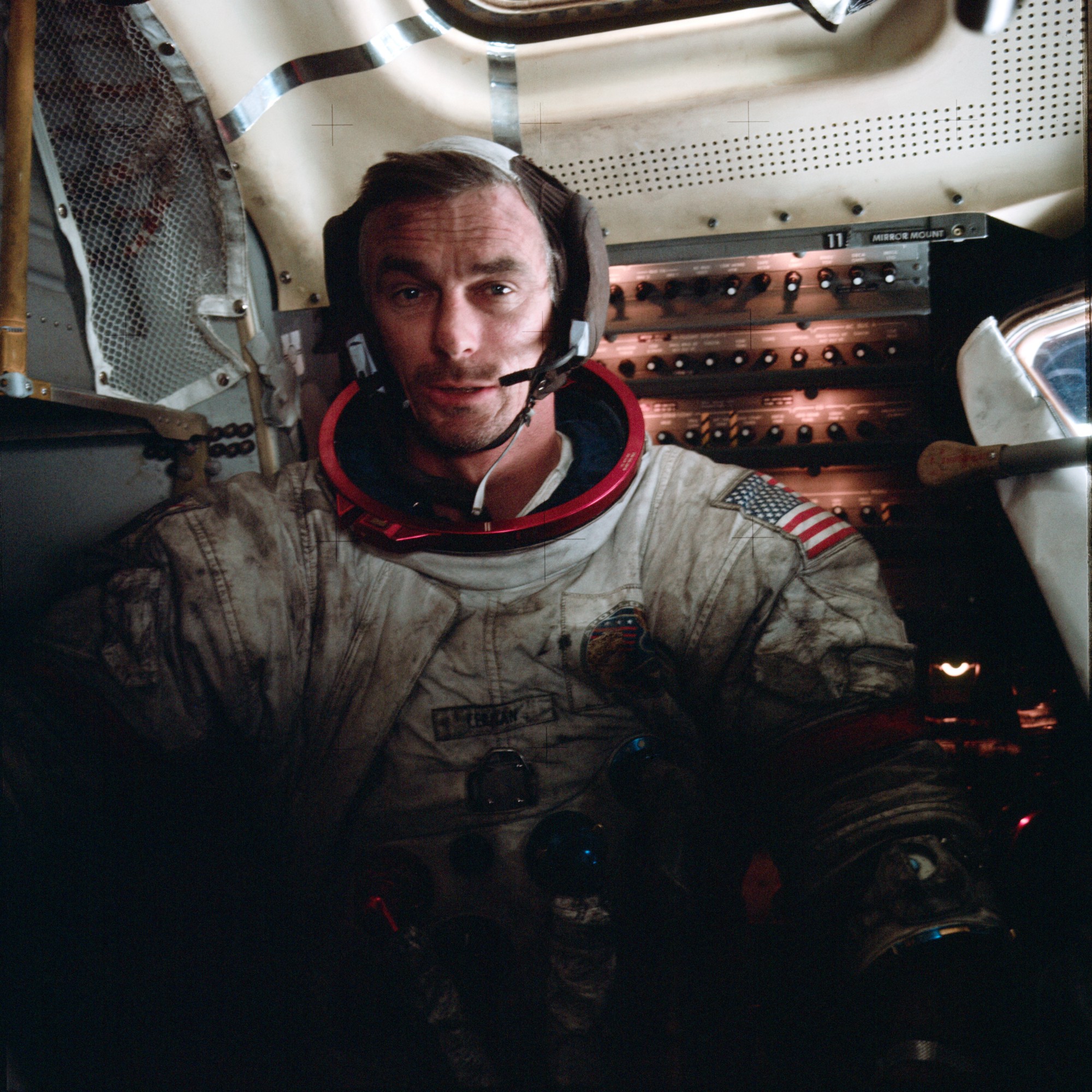 Apollo 17 astronaut Eugene Cernan covered in extraterrestrial dust, which makes his white suit look black with dirt from the waist to the shoulders.