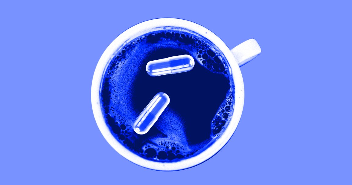 Some pills float in a blue tinted cup of coffee