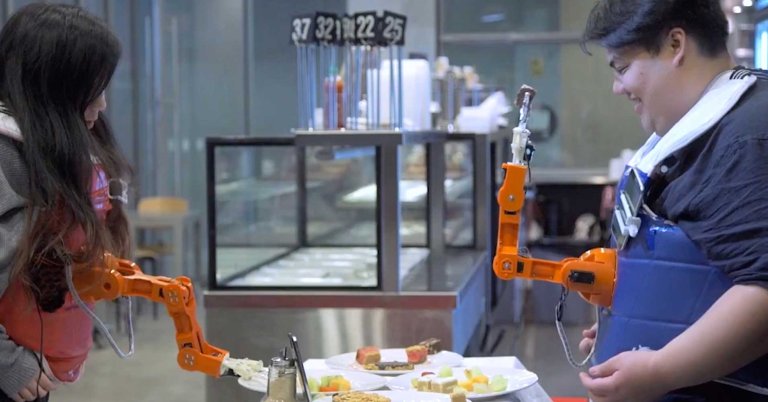 Arm-A-Dine is a robot arm that picks up food and feeds it to whichever human looks happiest. If you want dinner, you'll have to smile for the camera.