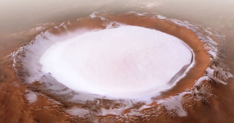 The ESA has released several photos of a massive ice-filled crater on Mars that are stunning enough to adorn a Christmas card.