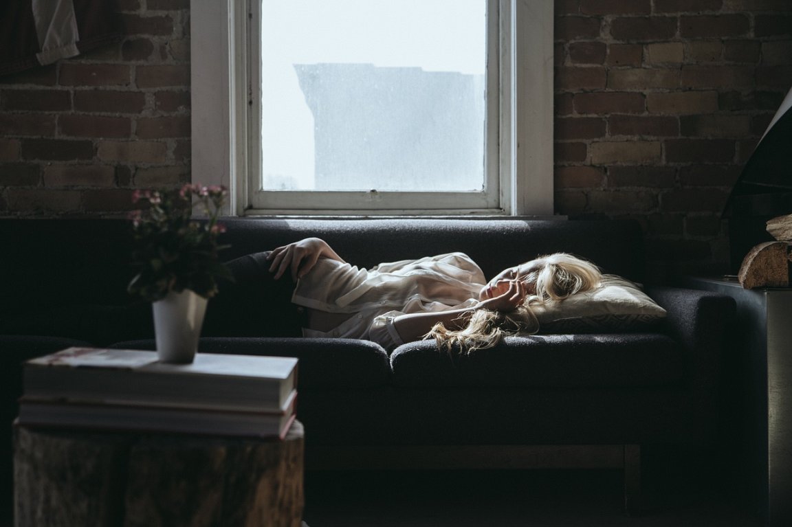 A sleeping woman on a sofa who may have taken sleeping pills to aid her slumber