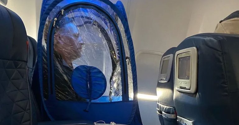 US business man and certified genius Rick Pescovitz was seen wearing a personal, transparent tent in a window seat on a flight to avoid the coronavirus.