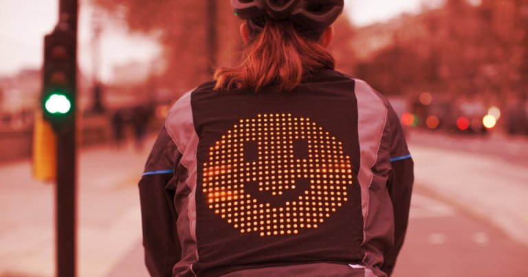 Ford has created a jacket for bicyclists that allows them to communicate with drivers using emoji displayed in LEDs on the rider's back.