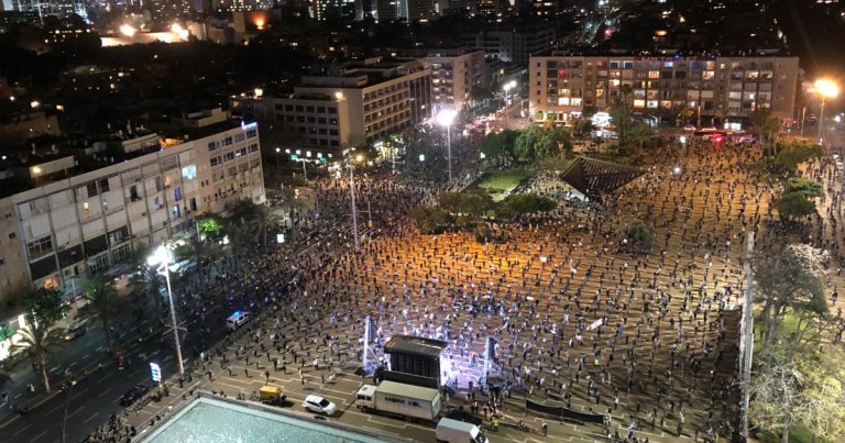 More than 2,000 Israelis flooded a square in Tel Aviv on Sunday to protest their government's overreaching coronavirus policies standing six feet apart.
