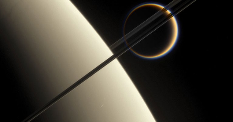 NASA just discovered that Saturn's moon Titan is creeping out into space 100 times faster than they previously thought it was.