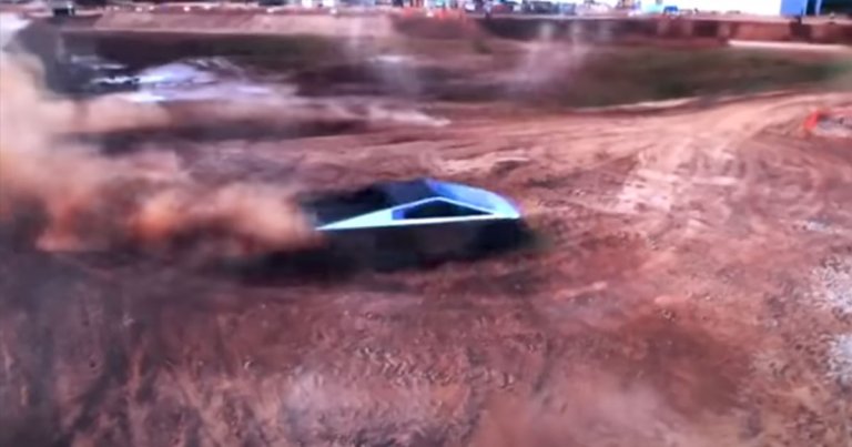 A newly leaked showroom video shows a Tesla Cybertruck with rear wheel steering and rear view mirrors tear it up on some dirt roads.