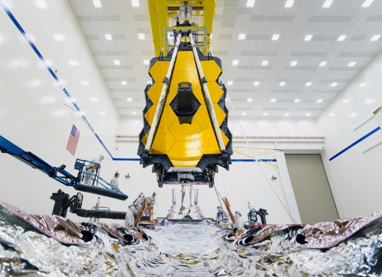 Once the James Webb Space Telescope got to an ESA spaceport, officials donned protective gear and took it out of its enormous box.