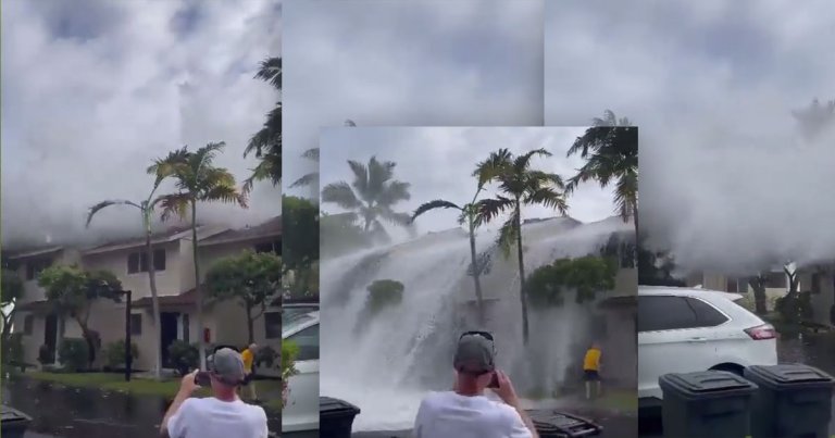 A shocking new video shows a massive tidal wave sweep over the top of a two-story condo in Keauhou, Hawaii, amid a "historic" ocean surf.