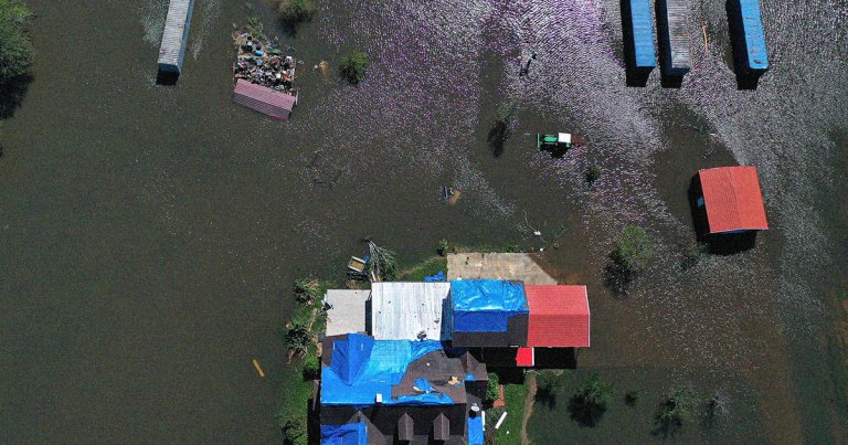 Twelve homes in a resettlement community for climate change survivors opened their doors to new owners this week in New Isle, Louisiana.