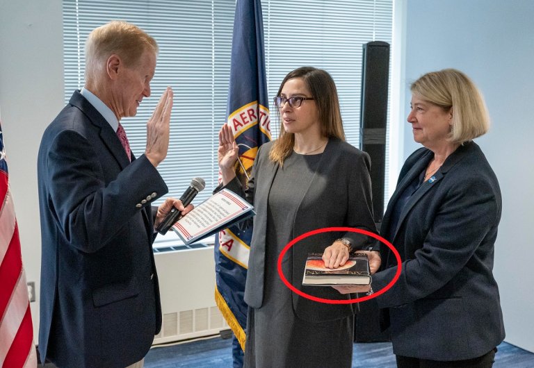 If you look closely at the photo that accompanies NASA's press release about the new Goddard Center director, you'll see something curious and delightful.