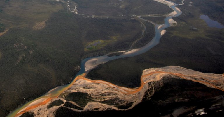 Global warming is thawing permafrost in Alaska and turning remote rivers from pristine glacier blue to rusty bright orange.