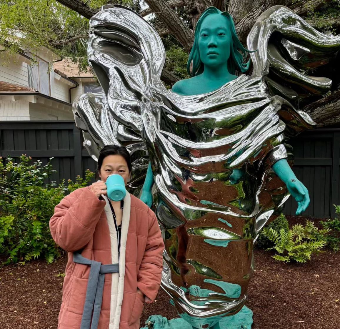 Mark Zuckerberg's wife, Priscilla Chan, looking underwhelmed by a giant statue of her.