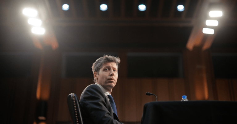OpenAI CEO Sam Altman testifies before Congress on May 8, 2025. Above him, several lights shine.