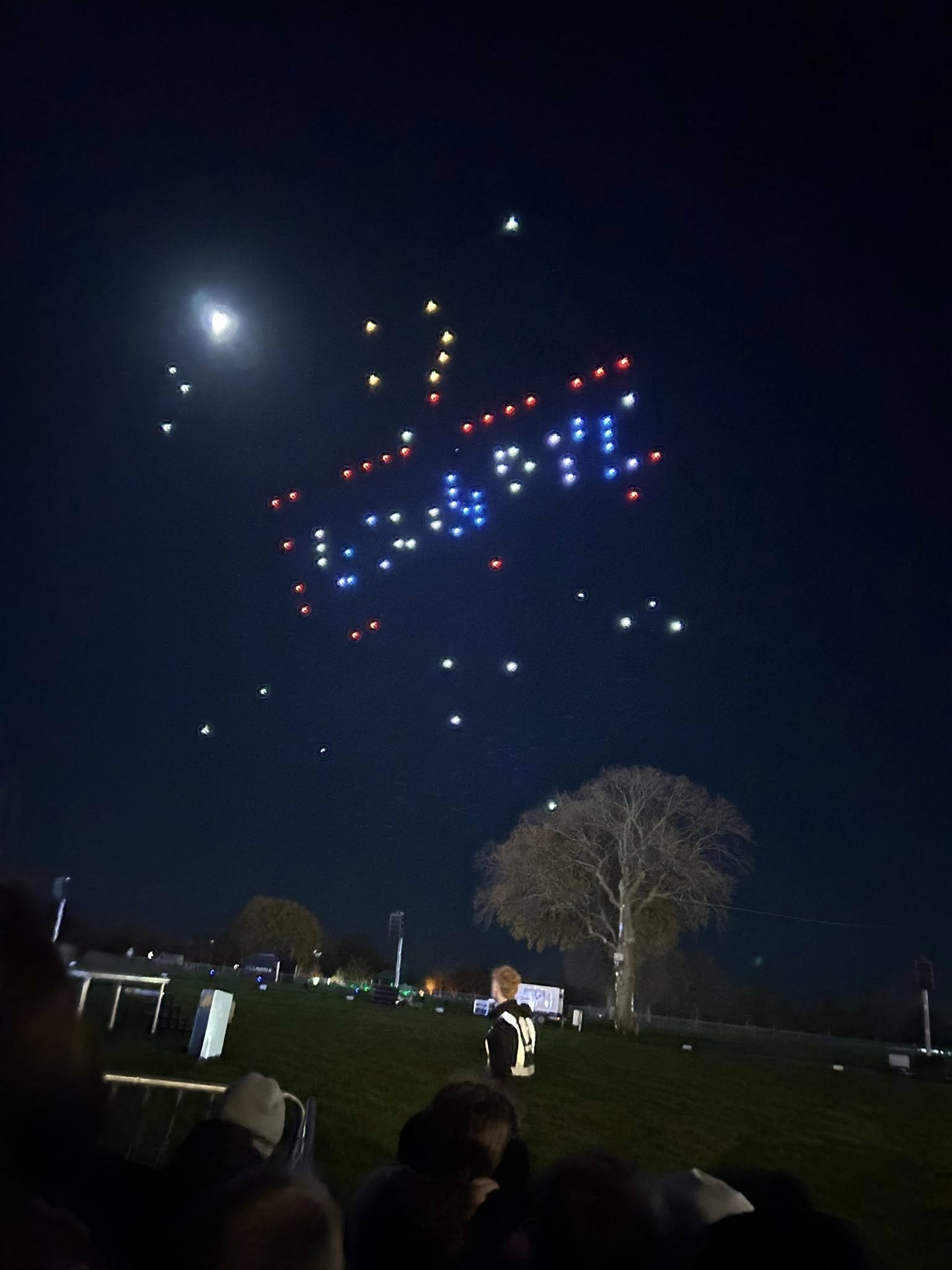 A few blue, red, and yellow LED drones make up a confusing holiday display, with obvious gaps in the image.