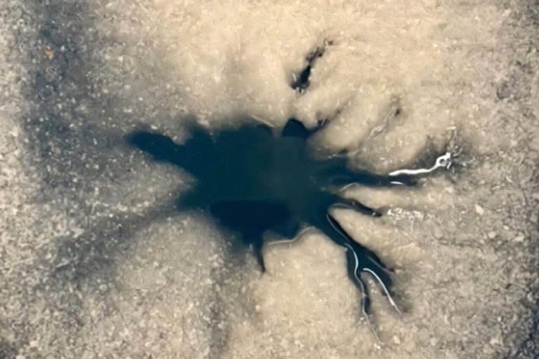 The spider-like formation could be evidence of epic eruptions of water that blast through Europa' surface.