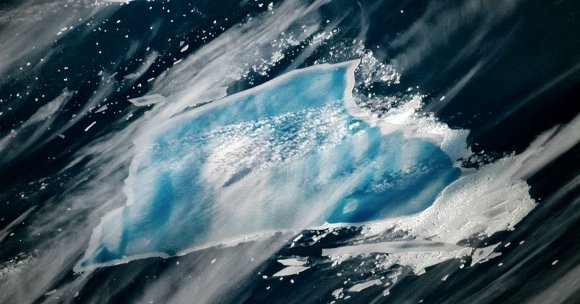 An enormous iceberg has turned an alarmingly bright shade of vivid blue — an alarming indication that it's about to completely disintegrate.
