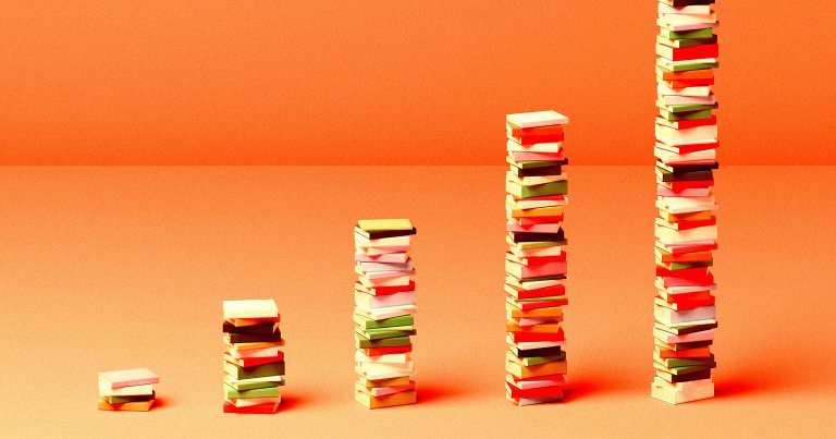 Five stacks of books arranged in ascending order of height from left to right, with the background and surface in shades of orange. The books have various colored covers including white, green, red, and yellow.