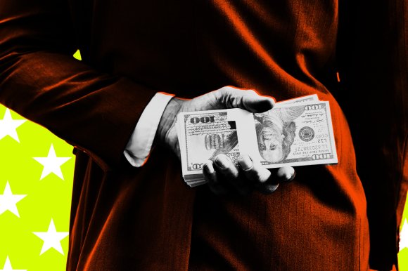 A person in a dark suit with a white shirt cuff is holding a stack of $100 bills behind their back. The background is bright yellow with white stars. The image has a high-contrast, stylized effect with orange highlights on the suit.
