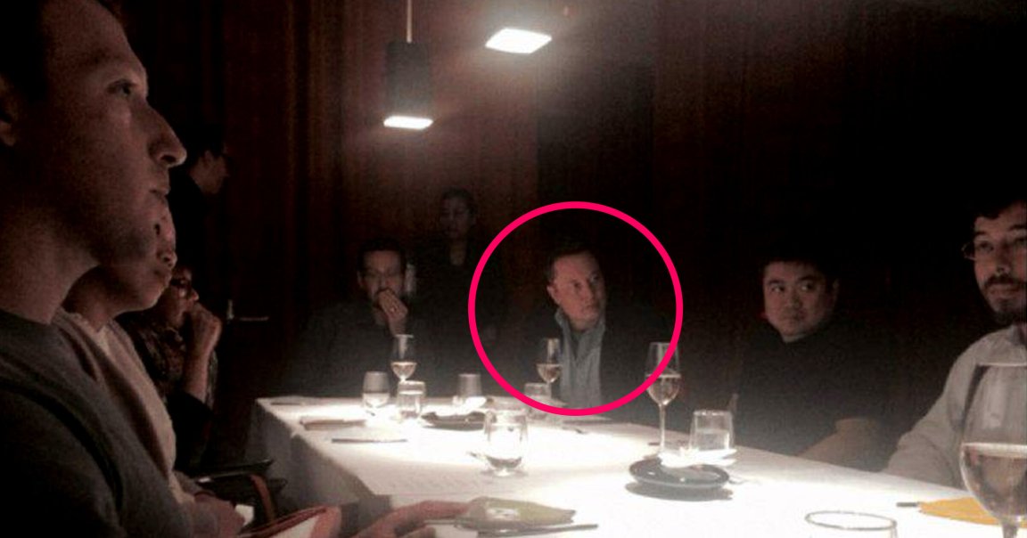 Elon Musk, Mark Zuckerberg, Joi Ito and others are sitting around a rectangular dining table with a white tablecloth in a dimly lit room. The table has several glasses of water and wine, plates, and cutlery. Two pendant lights hang above the table, casting light on the center. Musk is highlighted by a red circle.