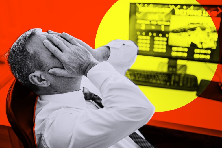 A man in a white shirt and tie sits in a chair with his hands covering his face, appearing stressed or frustrated. In the background, a computer monitor displays blurred financial data, highlighted by a yellow circle against a red backdrop.