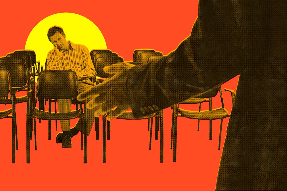 A man sits alone in a room filled with empty chairs, resting his head on his hand with a contemplative or tired expression. In the foreground, a person in a suit extends an open hand toward the seated man. The background is a bold orange with a large yellow circle behind the seated man, creating a dramatic and stylized contrast. The image has a textured, almost halftone effect.