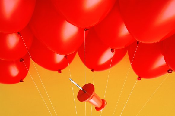 A group of red balloons tied with white strings against a yellow background, with a large red pushpin floating among them.