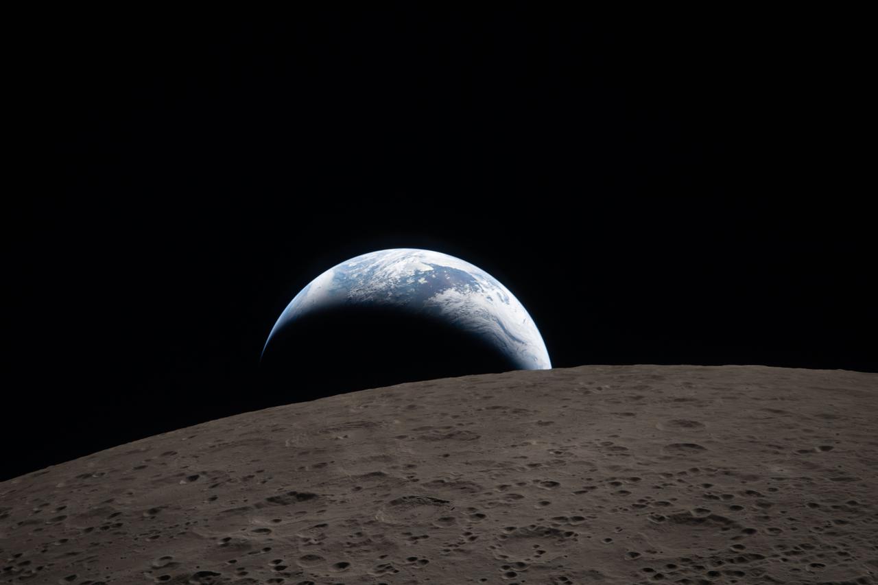 Earthset captured through the Orion spacecraft window at 6:41 p.m. EDT, April 6, 2026, during the Artemis II crew’s flyby of the Moon.