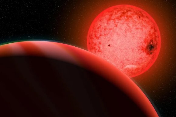 A large red planet with a smooth surface and faint bands is in the foreground, partially shadowed. Behind it is a bright red star with visible sunspots and a glowing aura, set against a backdrop of a star-filled space.