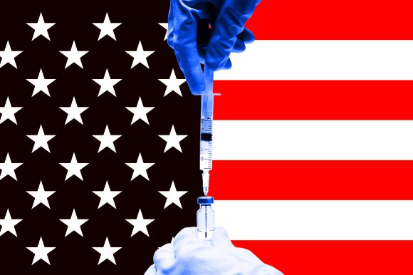 A pair of gloved hands holding a syringe and a vaccine vial, with the syringe needle inserted into the vial. The background features a stylized American flag with white stars on a black field on the left and red and white stripes on the right. The image has a high-contrast, blue-tinted effect on the hands and syringe.