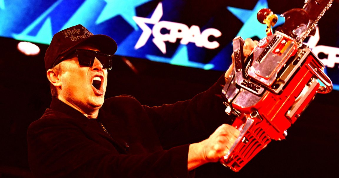 Elon Musk, wearing a black cap and large black sunglasses, is holding a red and silver chainsaw with the words "MAKE AMERICA GREAT AGAIN" on it at CPAC.