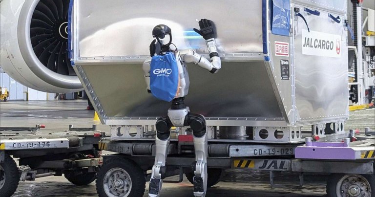 A humanoid robot is shown unloading a jet at an airport.
