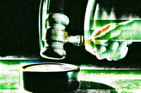 A hand holding a wooden judge's gavel poised above a round sound block, with a high-contrast, glitch-like effect in green and white tones.