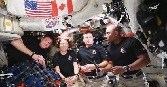 NASA astronauts Reid Wiseman, Victor Glover and Christina Koch, and Canadian astronaut Jeremy Hansen float inside NASA's Moon spacecraft.