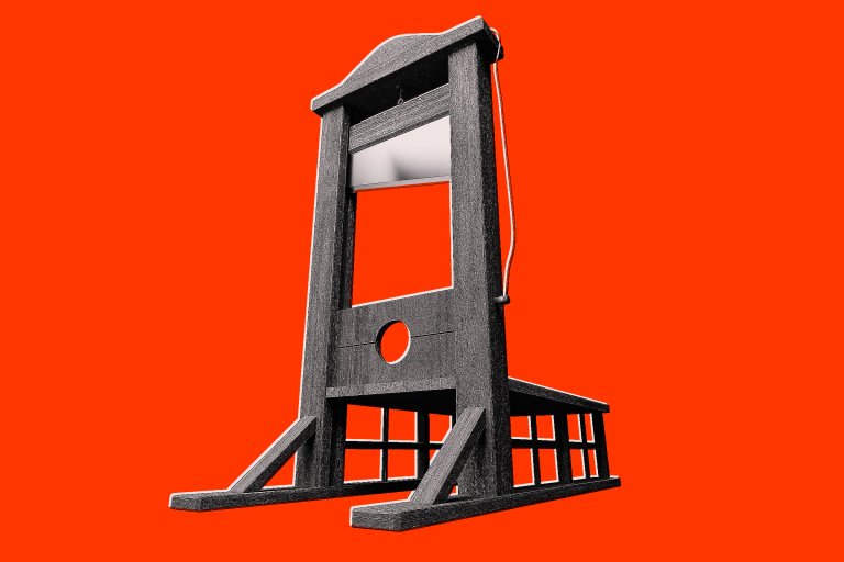 A wooden guillotine with a metal blade, shown against a bright red background.