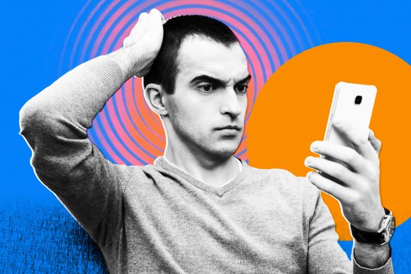 A man with short dark hair wearing a gray sweater is looking at a white smartphone with a confused or concerned expression. His left hand is on the back of his head, and he is wearing a wristwatch on his right wrist. The background features a blue color with an orange circle and pink concentric rings behind his head.