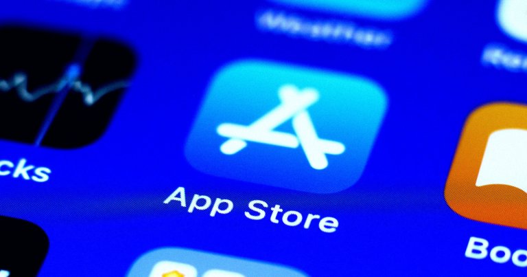 Close-up of the Apple App Store icon on a digital screen, featuring a blue square with a stylized white "A" made of three lines. The text "App Store" is visible below the icon.