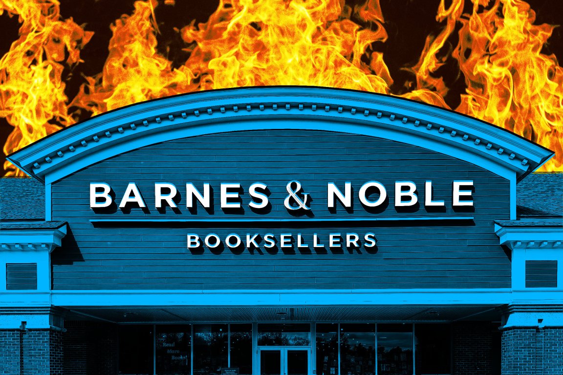 Barnes & Noble bookstore facade with large flames in the background, creating a dramatic contrast with the building's blue-toned exterior.
