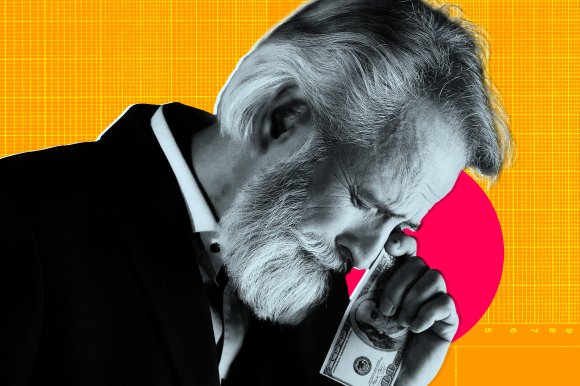 An older man with gray hair and a beard is using a folded hundred-dollar bill to wipe tears from his face, appearing distressed or contemplative. He is wearing a dark suit jacket over a white shirt. The background is bright orange with a grid pattern and a large red circle behind his head.